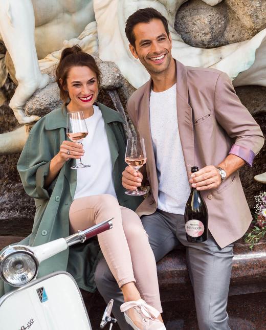 Mann und Frau trinken Rosato beim Brunnen