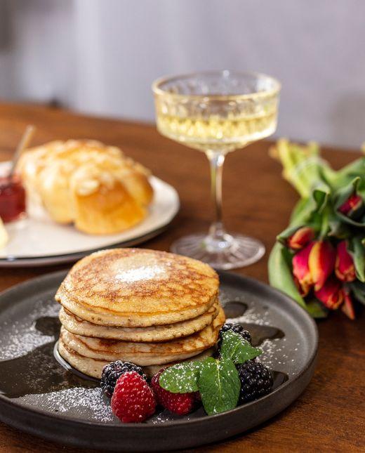 Pancakes und Sekt in einer Sektschale auf einem Tisch